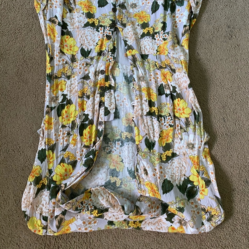 A yellow flowered romper with pockets